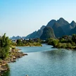 f9391603-0141-4517-b986-8845756d4799-serene-river-scene-with-fishermen-majestic-mountains.jpg