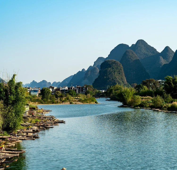 f9391603-0141-4517-b986-8845756d4799-serene-river-scene-with-fishermen-majestic-mountains.jpg